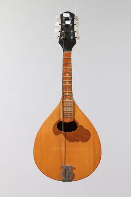 an image of a mandolin hanging from a string on a wall