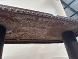 a close up of a metal table with rivets on it