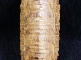 a close up of a wooden object on a black cloth