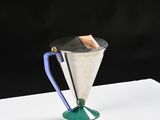 an image of a metal cup with a wooden handle on a white surface
