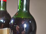 two bottles of wine sitting next to each other on a table