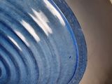 a close up of a toilet with a blue bowl in it