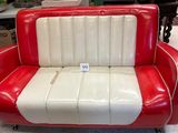 a red and white couch that is sitting in a room