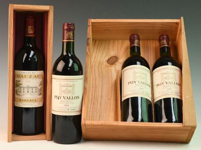 three bottles of red wine in a wooden box on a table