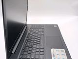 a black laptop with a black keyboard on a white surface