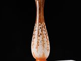 a glass vase sitting on top of a white table