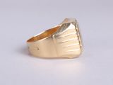 an image of a gold ring on a white surface