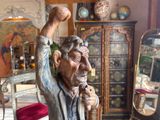 a statue of an old man holding a cane in a living room