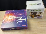 a box of star academy next to a box of star academy