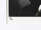 a black and white photo of a man with a tie