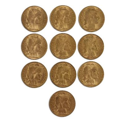 a close up of a bunch of gold coins on a white surface