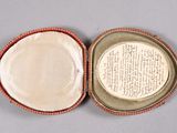 an open box with a plate inside of it sitting on a table