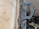 a silver tray with a handle on top of a marble table