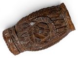 an image of a carved wooden object on a white surface