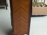 a small cabinet with a marble top in a store