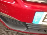 a close up of a red car with a license plate on it