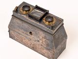 a small metal box with two lenses on it