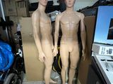 two mannequins standing next to each other in a room