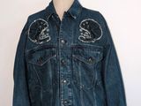denim jacket with patches on the front and back of a mannequin torso