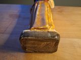 a statue of a person sitting on a wooden table