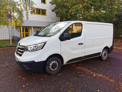 the white van is parked in the parking lot outside of a building