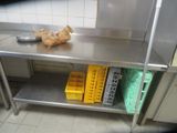 a stainless steel table with baskets on it in a kitchen