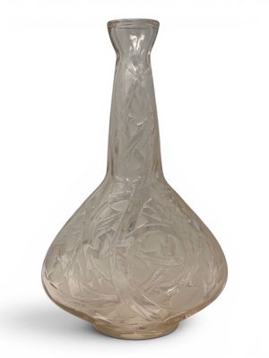 a glass vase that is sitting on a white surface