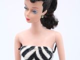a doll that is dressed in a zebra print bodysuit
