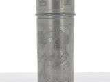 an old metal canister with a picture of a woman on it