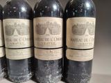 four bottles of wine are lined up on a table