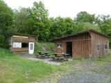 a small cabin with a picnic table in front of it