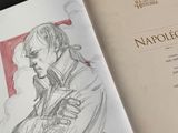 an open book with a drawing of a man holding a gun