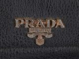 a prada black leather wallet with a logo on the front
