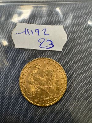 a close up of a gold coin with a label on it