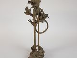 a metal sculpture of a bird on a branch