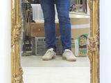 a woman standing in front of a mirror taking a selfie
