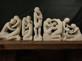 a sculpture of a group of people sitting on a table