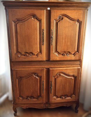 a wooden cabinet that is sitting on a wooden floor