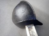 a knife sticking out of a helmet on a table