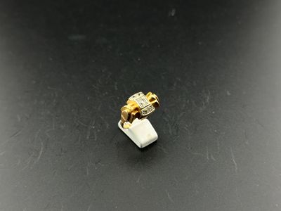 a close up of a white and gold ring on a black surface