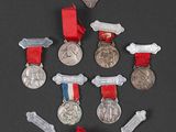 a lot of medals and medals on a black surface