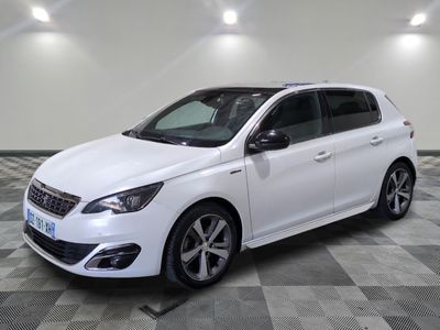 the white car is parked on a checkered floor in the garage