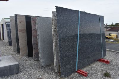 a pile of granite blocks sitting on the side of the road