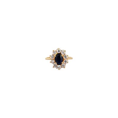 an image of a gold ring with a blue sapphire and white diamonds