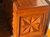 a wooden chest sitting on the floor in a room