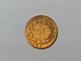 a close up of a gold coin on a white surface