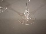 three wine glasses sitting on a table next to each other