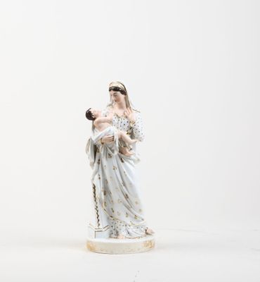 figurine of a woman holding a baby in her arms