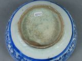a blue and white bowl with a label on it