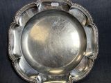 une assiette en argent sur fond noir, avec un fond noir